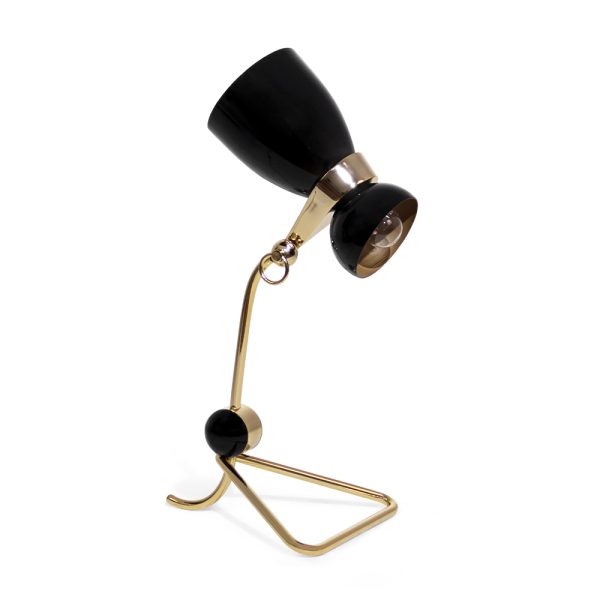Amy vintage table lamp is a lighting design inspired by one of the greatest British singers and songwriters of all times. With a glossy black lampshade that resembles her iconic hair and a small brass detail that reminds us of her golden earring, 100% handmade in Portugal, with a gold-plated finish and a glossy black coat applied to the body, this small brass lamp is perfect for a vintage bedroom, or a retro home office.