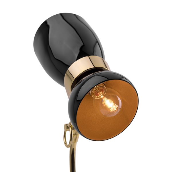 Amy vintage table lamp is a lighting design inspired by one of the greatest British singers and songwriters of all times. With a glossy black lampshade that resembles her iconic hair and a small brass detail that reminds us of her golden earring, 100% handmade in Portugal, with a gold-plated finish and a glossy black coat applied to the body, this small brass lamp is perfect for a vintage bedroom, or a retro home office.