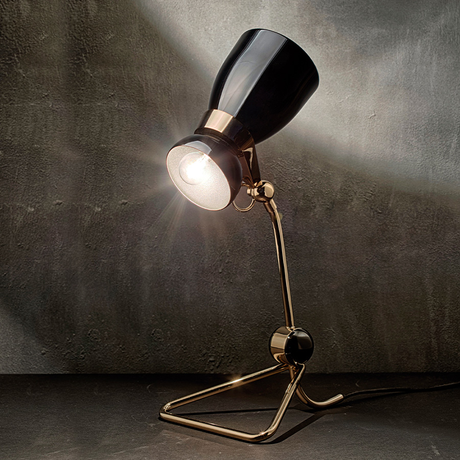 Amy vintage table lamp is a lighting design inspired by one of the greatest British singers and songwriters of all times. With a glossy black lampshade that resembles her iconic hair and a small brass detail that reminds us of her golden earring, 100% handmade in Portugal, with a gold-plated finish and a glossy black coat applied to the body, this small brass lamp is perfect for a vintage bedroom, or a retro home office.