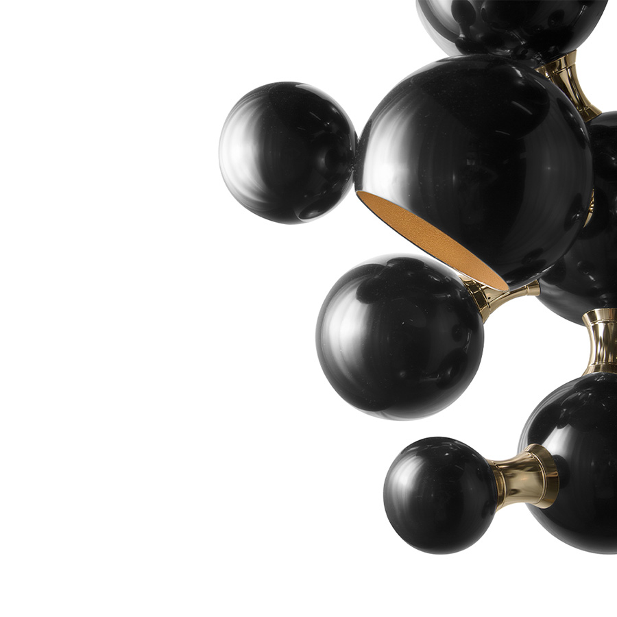 Atomic wall light is a mid-century modern lighting design inspired by the atomic discoveries of the mid-20th century. With multiple round shades that resemble the molecular composition of the atom, this interior wall light can give a fun twist to a contemporary home decor. Its body is handmade in brass and steel, with both a glossy black and a gold-plated finish.