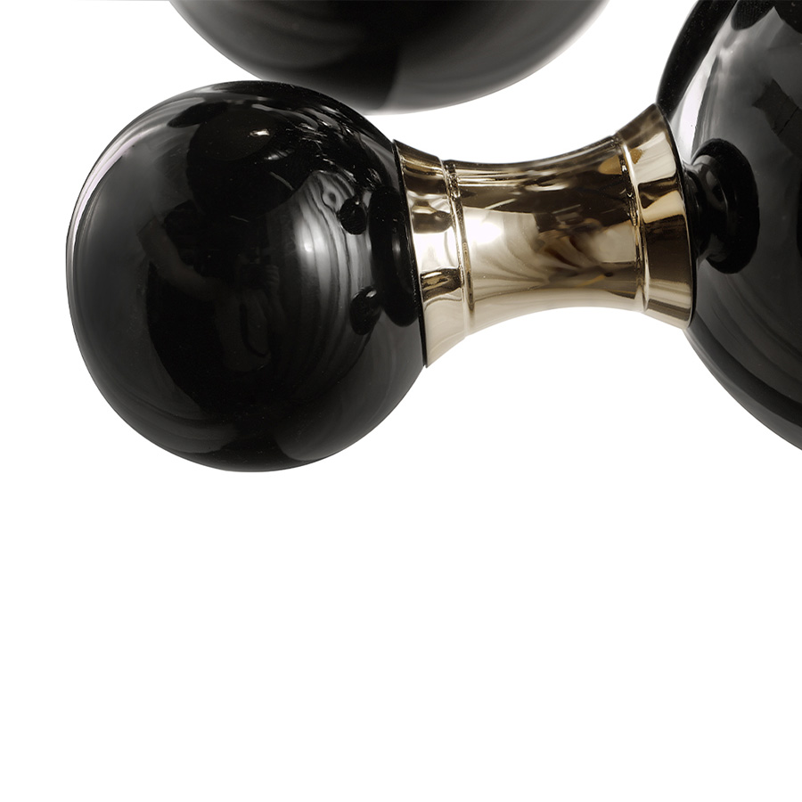 Atomic wall light is a mid-century modern lighting design inspired by the atomic discoveries of the mid-20th century. With multiple round shades that resemble the molecular composition of the atom, this interior wall light can give a fun twist to a contemporary home decor. Its body is handmade in brass and steel, with both a glossy black and a gold-plated finish.