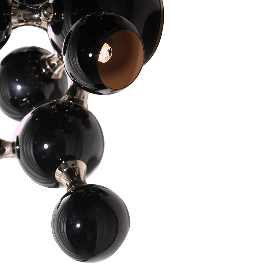 Atomic wall light is a mid-century modern lighting design inspired by the atomic discoveries of the mid-20th century. With multiple round shades that resemble the molecular composition of the atom, this interior wall light can give a fun twist to a contemporary home decor. Its body is handmade in brass and steel, with both a glossy black and a gold-plated finish.