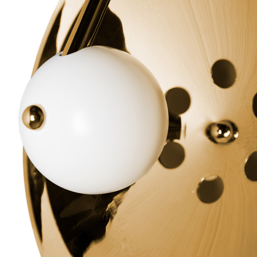 Basie wall light fixture is a modern representation of the sci-fi aesthetics of the 1960s. The vintage mid-century lamp has a set of distinctive features which make it a stunning statement piece. It is an indoor wall light handmade in brass, with a center shade made in Aluminium and a mesmerizing gold-plated standard finish. The lamp shade is lacquered a glossy white for a more modern look.