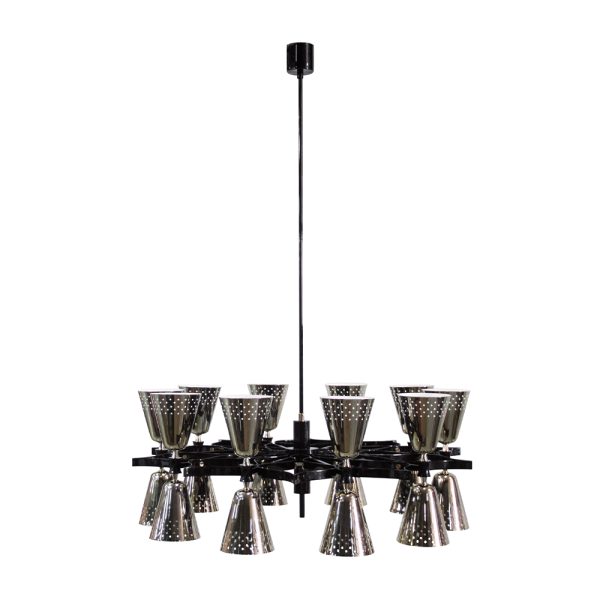 A revival of the mid-century modern design classics, Charles contemporary chandelier is a simple lighting design with a lot of character. It features 20 lampshades, all of them handmade in brass, with perforated details on the top. A copper plated finish is applied to the body of the lamp at the end of the process, creating a more contemporary vibe.