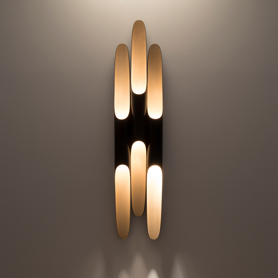 Coltrane mid-century wall sconce is inspired by the famous John Coltrane. Made from three original Coltrane lamps adjacent to one another to create a new design, this lighting piece is sure to steal the scene in your decor! Handmade in steel by DelightFULL’s skilled artisans, it is a great example of how less is more. This wall light fixture has matte black and gold powder paint finishes, which give it a more contemporary style.