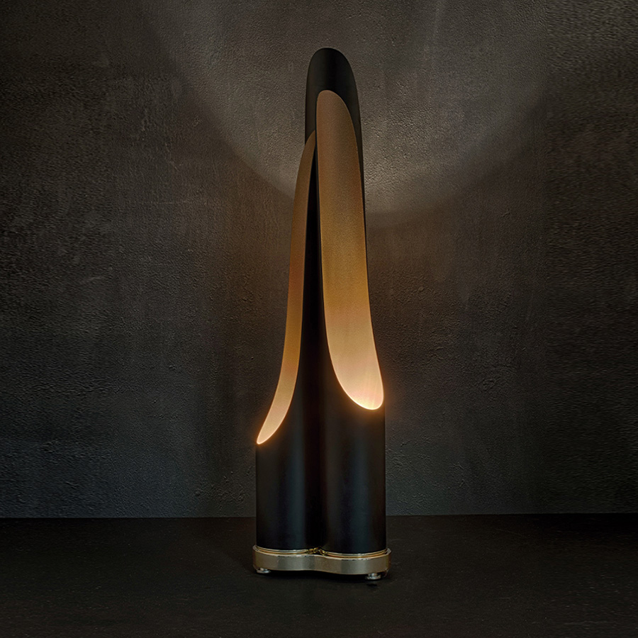 The mid-century Coltrane table light is a modern lighting fixture, which embodies the contemporary principles of minimalism. With this in mind, DelightFULL’s designers came up with a minimal black table lamp with three tubes that cast the most soothing glaze. This modern desk lamp is handmade in brass and steel, with a gold-plated base that is topped up with a matte black finish on the three shades. It serves as a great bedside table lamp, as well as a unique entryway table light.
