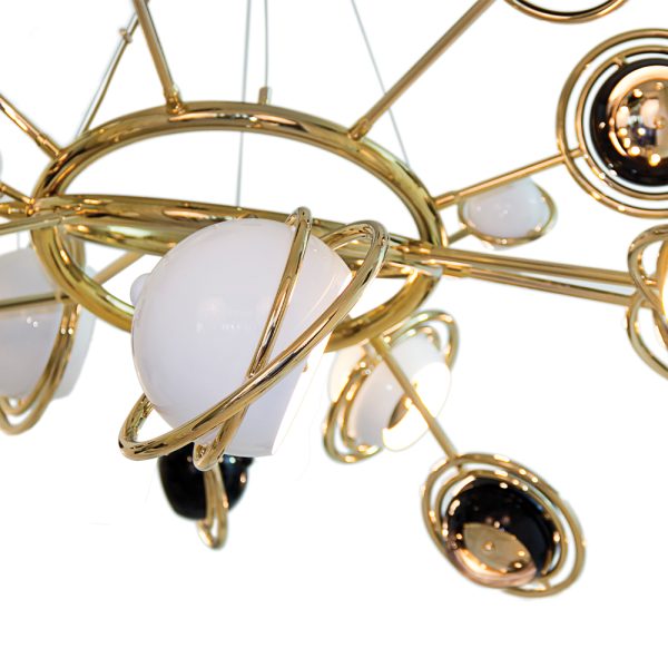 Designed as a tribute to the mid-20th century race to space, Cosmo modern chandelier is inspired by space, galaxies and the planets that surround us. It is a memorable lighting fixture, with very unique details that make it the luxurious bespoke design piece that it is. Handmade in brass and steel, the body is covered by a gold-plated finish, while the stainless steel shades are lacquered a glossy black and glossy white on the outside.