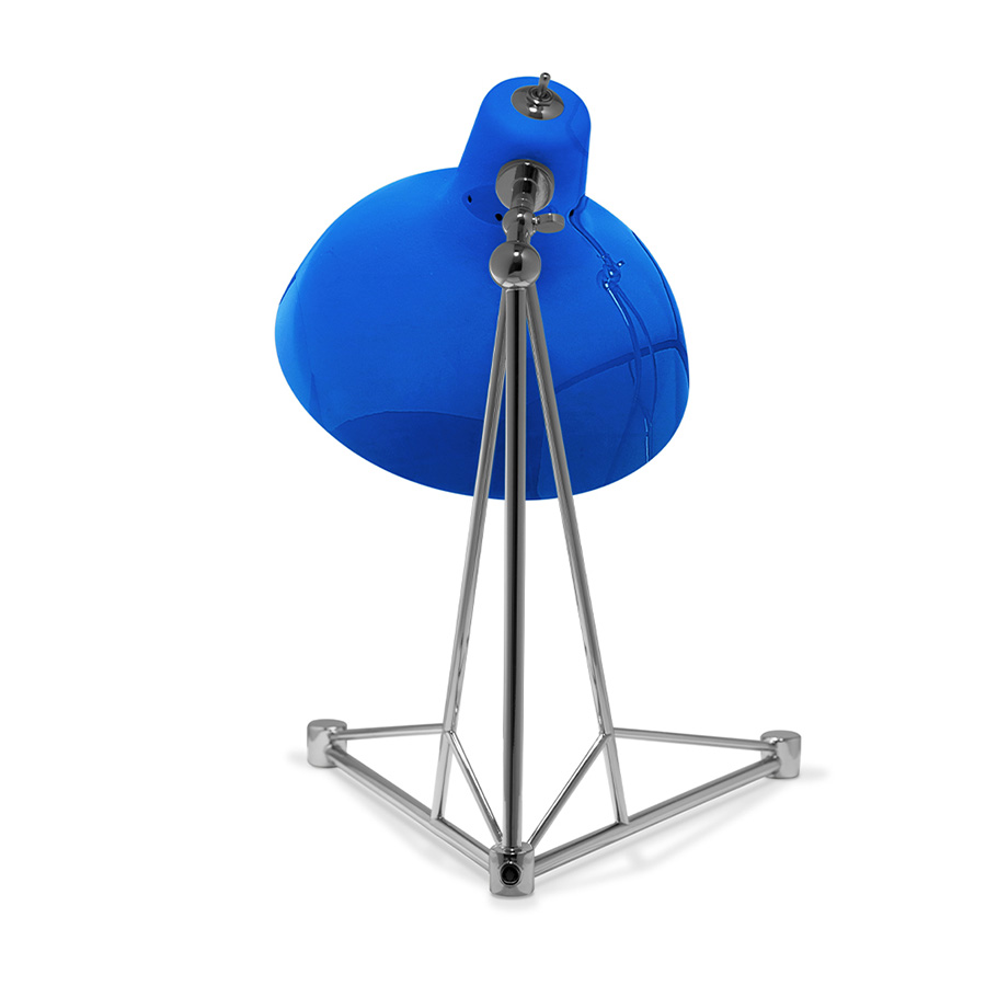 It is a handmade lamp built with materials such as brass and Aluminium. Brass was used on the body, whilst Aluminium was chosen for the shade. The Aluminium shade is lacquered a glossy red on the outside and matte white on the inside, while for the body a nickel-plated finish was chosen. However, both these colors and finishes can be customized according to your needs. having a movable and adjustable shade, that casts light to where it is needed.