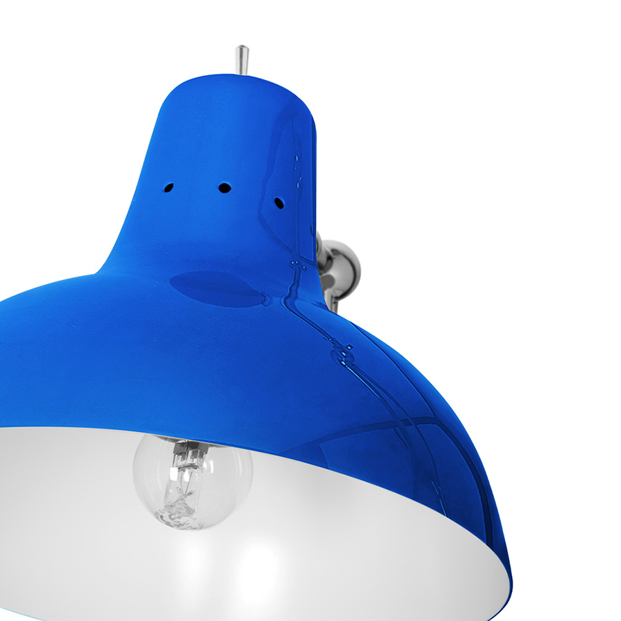 It is a handmade lamp built with materials such as brass and Aluminium. Brass was used on the body, whilst Aluminium was chosen for the shade. The Aluminium shade is lacquered a glossy red on the outside and matte white on the inside, while for the body a nickel-plated finish was chosen. However, both these colors and finishes can be customized according to your needs. having a movable and adjustable shade, that casts light to where it is needed.