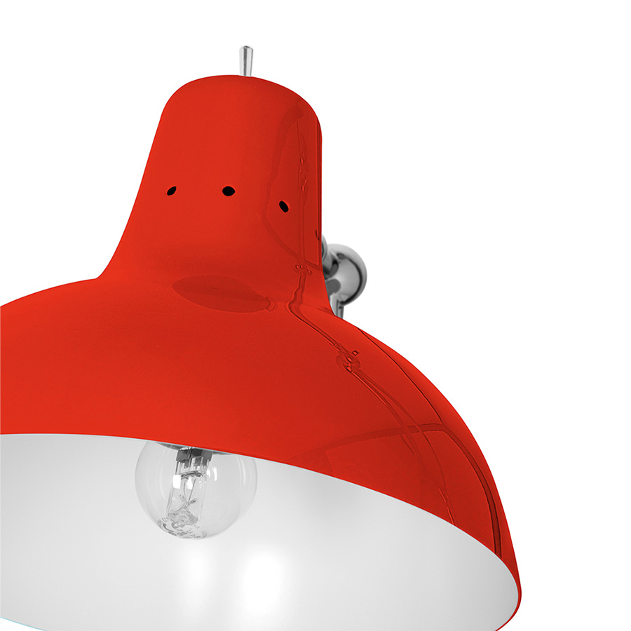 It is a handmade lamp built with materials such as brass and Aluminium. Brass was used on the body, whilst Aluminium was chosen for the shade. The Aluminium shade is lacquered a glossy red on the outside and matte white on the inside, while for the body a nickel-plated finish was chosen. However, both these colors and finishes can be customized according to your needs. having a movable and adjustable shade, that casts light to where it is needed.