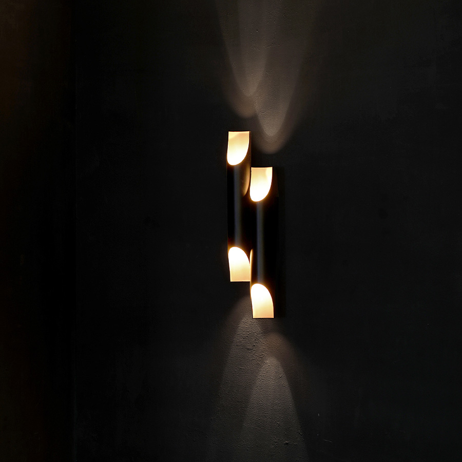Meet Galliano, a special modern wall lamp with a minimalist style that allows you to fit it in every room of your home, regardless the style of your interior design. It’s not coincidence that this wall lamp is one of DelightFULL’s top best sellers. Made of iron with a matte black exterior and a gold powder paint interior finishing, Galliano produces a unique lighting effect when you see light being casted thought its pipes.