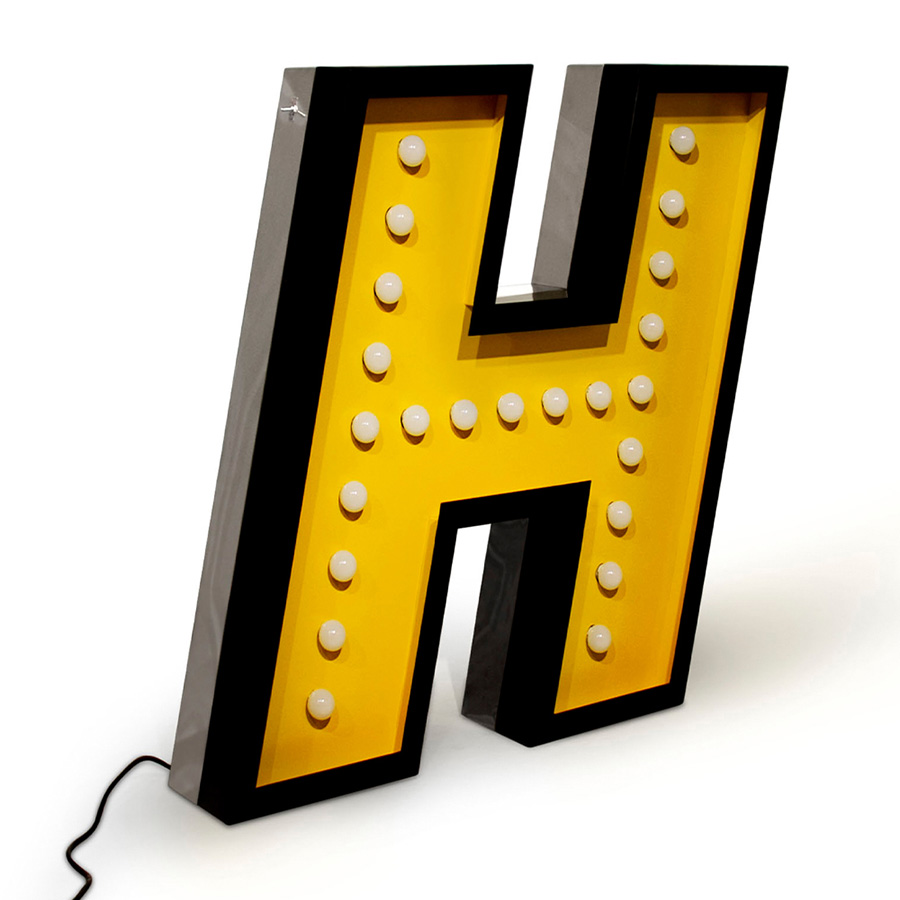 H stands for handmade and for one of the most beloved typefaces hits of this collection. Modern and energetic, this letter draws attention by its standard finishes in italic, with a yellow color and black outline. Made of shiny stainless steel and shining with 17 bulbs, this marquee letter design is available for colour customization and in a mini version! And its also able to put into your floor or your sleek wall. Made only for your interiors.
