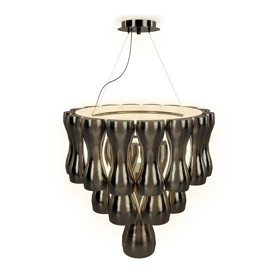 The Krown light is a unique chandelier. It is about sensualizing the glass-removing, the antiquated facets and stereotypes from the history of lighting, while still retaining its beauty. It has a geometric design of combined sculptural shades and its structure is handmade in brass. This chandelier shines even when it is switched off, but it gets even more beautiful when you see the light being cast through the shades.