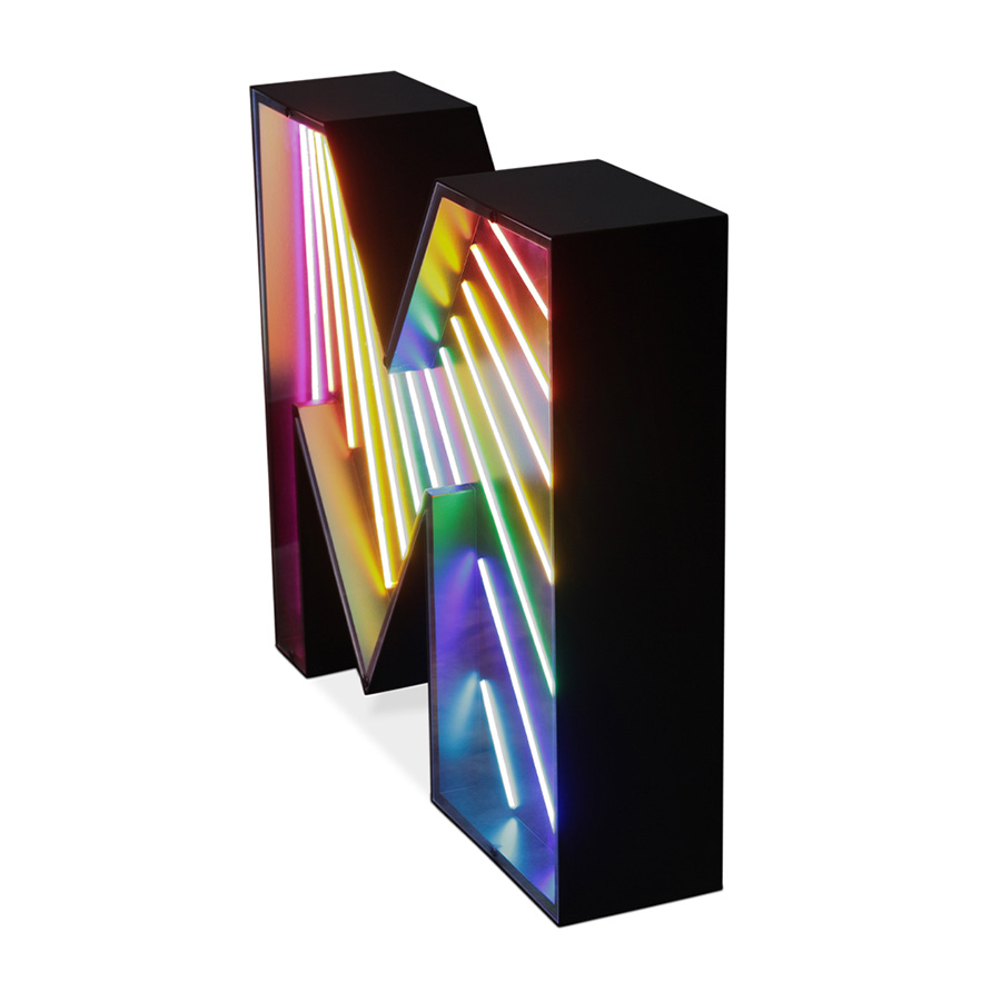 An eye-catching touch to a big, bold and bright marquee letter design. A unique way of bringing a unique, colourful and cheerful touch to any exterior or interior design project. With its stunning rainbow neon effect, this versatile lighting design can be placed in the wall or on the floor. Coming with a large anti-reflective acrylic panel to protect the neons this marquee letter design has 1 meter and its handmade in acrylic and Aluminium. Customizable on demand it's also available in a mini version, this marquee letter is perfect for a fun lobby.