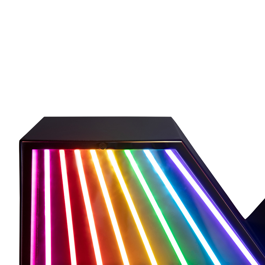 An eye-catching touch to a big, bold and bright marquee letter design. A unique way of bringing a unique, colourful and cheerful touch to any exterior or interior design project. With its stunning rainbow neon effect, this versatile lighting design can be placed in the wall or on the floor. Coming with a large anti-reflective acrylic panel to protect the neons this marquee letter design has 1 meter and its handmade in acrylic and Aluminium. Customizable on demand it's also available in a mini version, this marquee letter is perfect for a fun lobby.