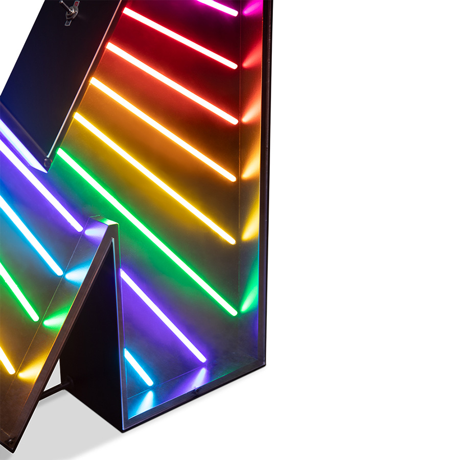 An eye-catching touch to a big, bold and bright marquee letter design. A unique way of bringing a unique, colourful and cheerful touch to any exterior or interior design project. With its stunning rainbow neon effect, this versatile lighting design can be placed in the wall or on the floor. Coming with a large anti-reflective acrylic panel to protect the neons this marquee letter design has 1 meter and its handmade in acrylic and Aluminium. Customizable on demand it's also available in a mini version, this marquee letter is perfect for a fun lobby.