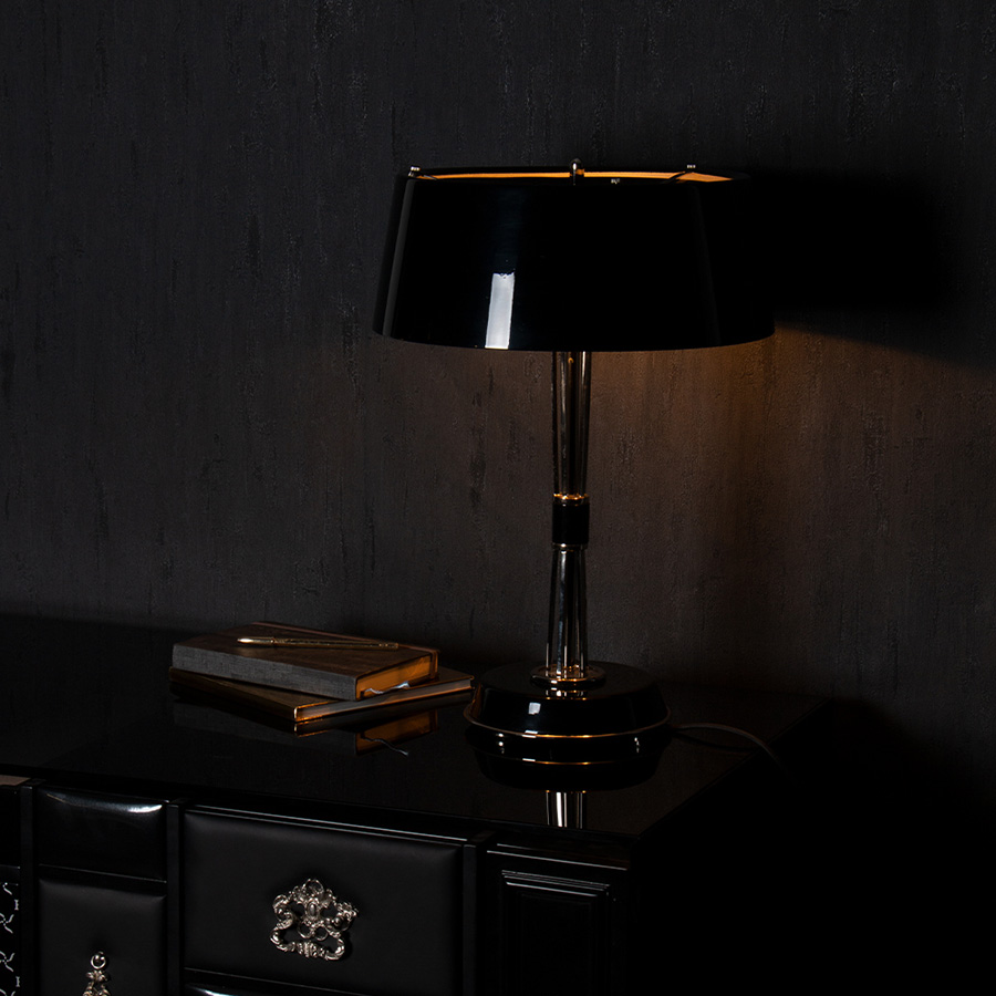 Miles table lamp is a classic mid-century modern table lamp, which brings back the sophisticated atmosphere of the 50s. The body has a copper plated finish for a more contemporary look, while the shade is lacquered a matte black on the outside and a white matte on the inside.It is essentially a copper table lamp that casts a soft glaze that will suit your modern entryway in the most flattering way.