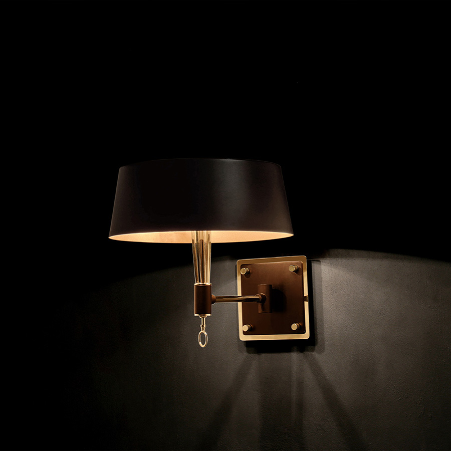 Miles wall lamp was inspired in one of the most influential and acclaimed figures in the history of jazz and 20th century music: Miles Davis. This modern wall light has the purpose to represent the impressive charisma of this outstanding jazz singer, in its innovative and sophisticated lighting features. Miles black wall sconce features a structure made in brass and the lamp shade in Aluminium.