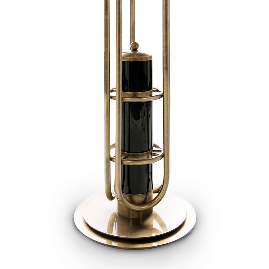 Neil floor lamp is a reminiscent lamp of the golden years of space. Around, brass base secures a black matte stem reaching up into three glossy black finished lampshades with a futuristic style. The three arms with flexible lights provide a good peripheric light range. The elegance of the continuous flowing center tubes gives a floating sensation to the whole piece, that would be perfect in a retro style living room next to a lounge chair or in a luxurious lobby.