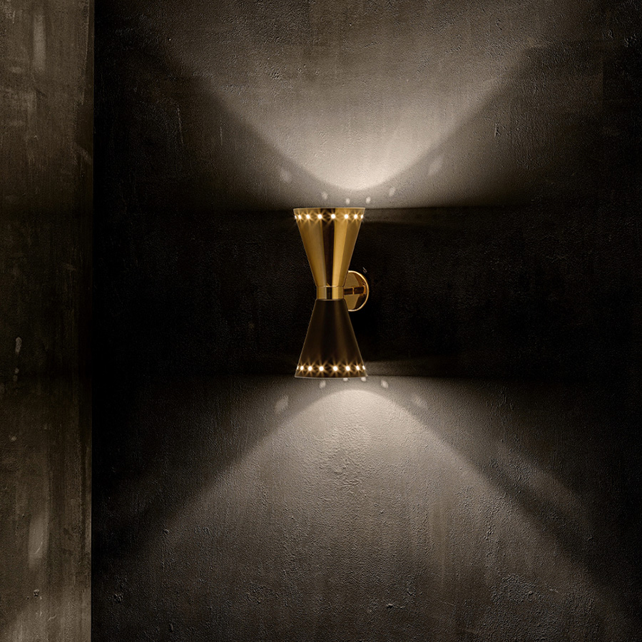 Piazzolla wall fixture is a pure 60’s stilnovo style that brings a retro touch to contemporary spaces. Featuring two Aluminium cones, this wall light fixture offers light both from top and bottom lamp shades to provide a subtle glow. With a dynamic and versatile look that can be applied to any setting, Piazzolla wall lamp can be mounted horizontally or vertically.
