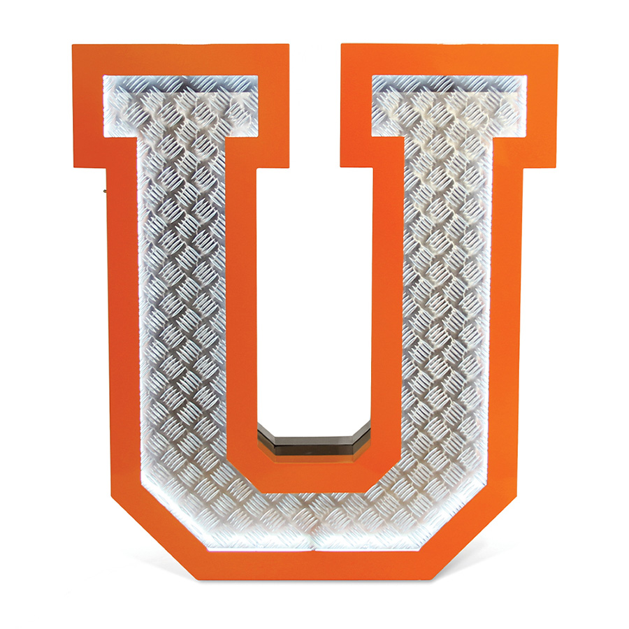 Inspired by the great 70's, the geometric lines and the exterior orange underlines that contour the Aluminium fixture is a sign of the times ahead. Covered with diamond plated steel that reflects the white neon glow of the marquee lighting design is the ones to characterizes this lighting fixture. Creating a new aura in any design project, this handmade lighting design has a 1 meter in height.