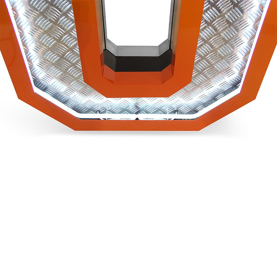 Inspired by the great 70's, the geometric lines and the exterior orange underlines that contour the Aluminium fixture is a sign of the times ahead. Covered with diamond plated steel that reflects the white neon glow of the marquee lighting design is the ones to characterizes this lighting fixture. Creating a new aura in any design project, this handmade lighting design has a 1 meter in height.